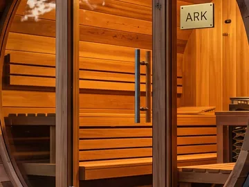 Detail: the glass door, the bench and the ARK plaque