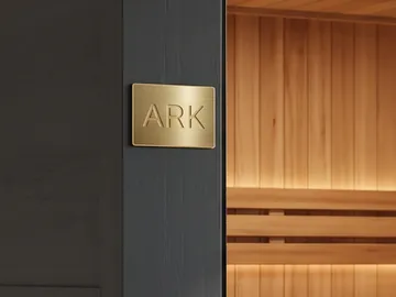 Detail: the gold ARK plaque on the frame